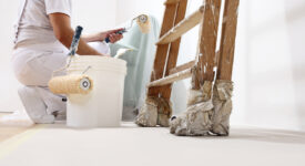 painter man at work with a roller, bucket and ladder, bottom view