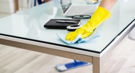Young Male And Female Cleaners Cleaning Office