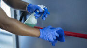 cleaning staff disinfecting the emergency door bar