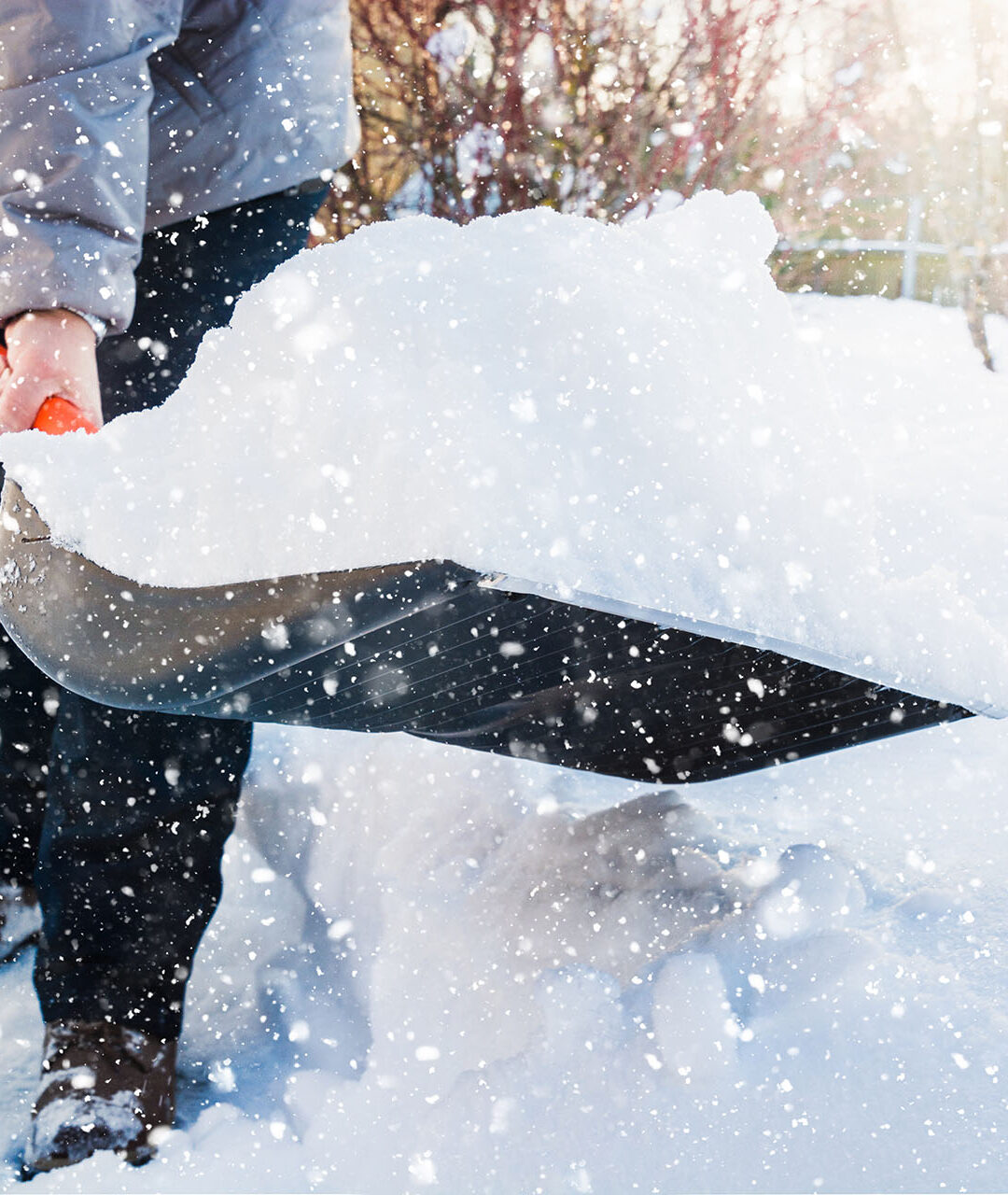 Snow removal. Man clearing snow by shovel after snowfall. Outdoors.