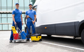 Guy With Vacuum Cleaner And Worker Near Truck