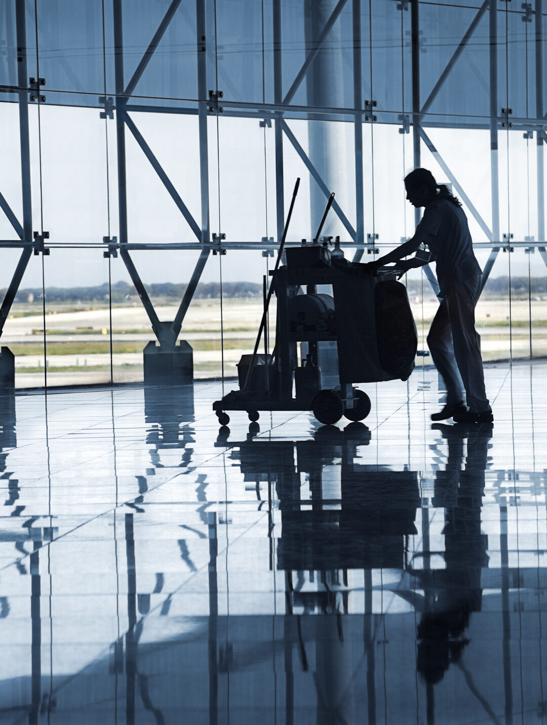 Barcelona City – Spain. May 20-2010:  Cleaning staff at Barcelona Terminal Airport lobby. Building architectural detail designed by spanish achitect Richard Bofill .