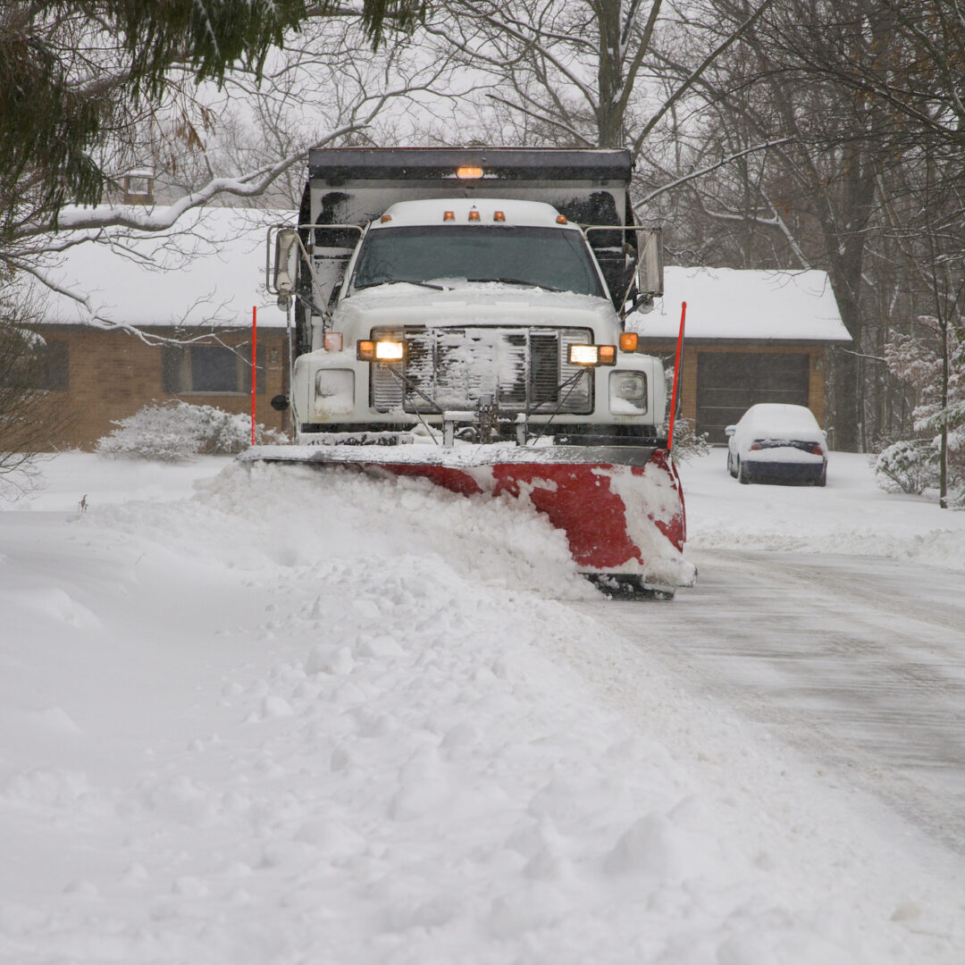Snow plow removing snow from street.