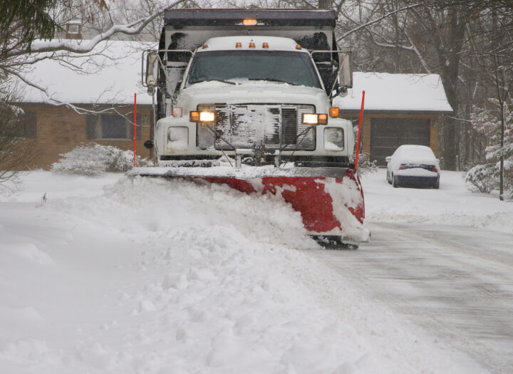 Snow plow removing snow from street. Snow plow removing snow from street.